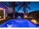 Stunning pool and spa with fire features at night at 15577 S 181St Ln, Goodyear, AZ 85338