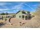 Backyard area of a house featuring an outdoor patio, a built in fire pit and desert landscaping at 16625 N Agate Knoll Pl, Fountain Hills, AZ 85268