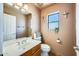 Bathroom featuring a toilet, window, and a single sink vanity with a mirror at 16625 N Agate Knoll Pl, Fountain Hills, AZ 85268