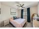 Comfortable bedroom featuring a ceiling fan, a painting, a window and a bed at 16625 N Agate Knoll Pl, Fountain Hills, AZ 85268