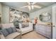 Bedroom featuring a white crib, comfortable chair, a dresser and a round mirror at 16625 N Agate Knoll Pl, Fountain Hills, AZ 85268