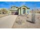 Inviting two-story home featuring a desert landscape, a brown garage door, and a welcoming front entrance at 16625 N Agate Knoll Pl, Fountain Hills, AZ 85268