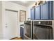 Laundry room featuring a washer, a dryer, a sink, and blue cabinets at 16625 N Agate Knoll Pl, Fountain Hills, AZ 85268