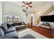 Comfortable living room with a large window, hardwood floors, and a staircase with wood banister at 16625 N Agate Knoll Pl, Fountain Hills, AZ 85268