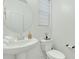 Small bathroom with toilet and pedestal sink at 1671 E Dogwood Ln, Gilbert, AZ 85295