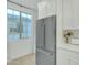 Kitchen with stainless steel refrigerator and white cabinets at 1671 E Dogwood Ln, Gilbert, AZ 85295