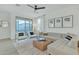 Spacious living room featuring a light gray sectional sofa and large windows at 1671 E Dogwood Ln, Gilbert, AZ 85295