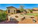 Landscaped backyard oasis with a fire pit and putting green at 18187 W Wind Song Ave, Goodyear, AZ 85338