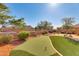 Putting green and patio area in a beautifully landscaped backyard at 18187 W Wind Song Ave, Goodyear, AZ 85338