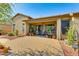 Covered patio with seating area and lush potted plants at 18187 W Wind Song Ave, Goodyear, AZ 85338