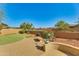 Landscaped backyard with a putting green and seating area at 18187 W Wind Song Ave, Goodyear, AZ 85338