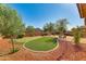 Putting green and patio area in a well-maintained backyard at 18187 W Wind Song Ave, Goodyear, AZ 85338