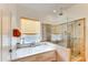 Relaxing bathroom with soaking tub and walk-in shower at 18187 W Wind Song Ave, Goodyear, AZ 85338