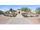 Inviting clubhouse entrance with lush landscaping, stone accents, and a welcoming walkway for residents and guests to enjoy at 18187 W Wind Song Ave, Goodyear, AZ 85338