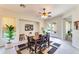 Dining room with a wooden table, access to backyard patio and ceiling fan at 18187 W Wind Song Ave, Goodyear, AZ 85338