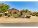 Single-story home with desert landscaping and a two-car garage at 18187 W Wind Song Ave, Goodyear, AZ 85338