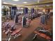 Modern fitness center equipped with various exercise machines, weights, and large windows at 18187 W Wind Song Ave, Goodyear, AZ 85338