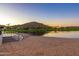 Sandy beach and stairs provide access to the lake at 18187 W Wind Song Ave, Goodyear, AZ 85338