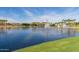 Serene lake view with water fountains and lush greenery at 18187 W Wind Song Ave, Goodyear, AZ 85338