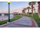 Curved walkway with lights along a lake at 18187 W Wind Song Ave, Goodyear, AZ 85338