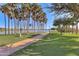 Scenic lakeside path lined with palm trees at 18187 W Wind Song Ave, Goodyear, AZ 85338