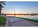 Scenic walkway along the lake at sunset at 18187 W Wind Song Ave, Goodyear, AZ 85338