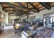 Spacious living room featuring a beamed ceiling, bar area, and refined decor for an upscale living experience at 18187 W Wind Song Ave, Goodyear, AZ 85338