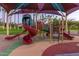 playground with shaded areas and play structures at 18187 W Wind Song Ave, Goodyear, AZ 85338