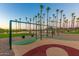 playground with swings and palm trees at 18187 W Wind Song Ave, Goodyear, AZ 85338