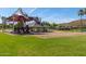 Playground with a shaded play area and swings at 18187 W Wind Song Ave, Goodyear, AZ 85338