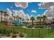 Exterior view of a community pool area, featuring a lighthouse-themed slide and manicured lawns at 18187 W Wind Song Ave, Goodyear, AZ 85338