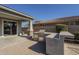 Outdoor kitchen with built-in grill and sitting bar at 18439 W Wind Song Ave, Goodyear, AZ 85338