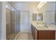 Double vanity bathroom with a large walk-in shower at 18439 W Wind Song Ave, Goodyear, AZ 85338