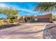 Desert landscape surrounds this beautiful home with stucco exterior, and a large garage at 19007 E Lazo Ct, Rio Verde, AZ 85263