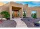 Elegant entryway with a wood door, stone flooring and desert landscaping at 19007 E Lazo Ct, Rio Verde, AZ 85263