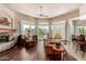 Bright living room featuring hardwood floors and a stone fireplace at 19007 E Lazo Ct, Rio Verde, AZ 85263