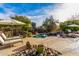 Lush pool area with patio furniture and umbrellas for shade at 19007 E Lazo Ct, Rio Verde, AZ 85263