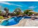 Relaxing kidney-shaped pool with surrounding landscaping and patio at 19007 E Lazo Ct, Rio Verde, AZ 85263