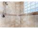 Large walk-in shower with glass block window and neutral tile at 19007 E Lazo Ct, Rio Verde, AZ 85263