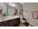 Clean bathroom with dark wood vanity, updated fixtures, and a large mirror at 20744 W Hamilton St, Buckeye, AZ 85396