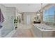 Elegant bathroom with a soaking tub, glass shower, and marble at 20744 W Hamilton St, Buckeye, AZ 85396