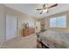 Comfortable bedroom featuring carpeted floors, built-in dresser, and ceiling fan at 20744 W Hamilton St, Buckeye, AZ 85396