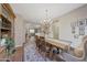 Bright dining area with hardwood floors, chandelier, and views to living room at 20744 W Hamilton St, Buckeye, AZ 85396