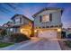 Two-story house with a large white garage door and landscaping at 20744 W Hamilton St, Buckeye, AZ 85396