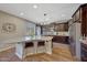 Kitchen island with granite countertop and seating for two at 20744 W Hamilton St, Buckeye, AZ 85396