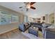 Living room with sectional sofa, pool view, and ceiling fan at 20744 W Hamilton St, Buckeye, AZ 85396