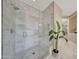 Spa-like shower with marble tile and glass enclosure at 20744 W Hamilton St, Buckeye, AZ 85396