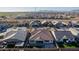 Aerial view of house highlighting its roofline, backyard, and surrounding community at 21160 E Cattle Dr, Queen Creek, AZ 85142