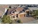 Single-Gathering home with brown roof and garage, aerial view at 21160 E Cattle Dr, Queen Creek, AZ 85142