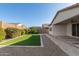 Artificial turf and a paved patio enhance this home's backyard at 21160 E Cattle Dr, Queen Creek, AZ 85142